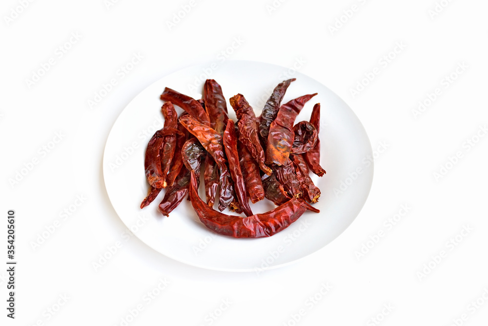 A plate of red dried chili on a white background.