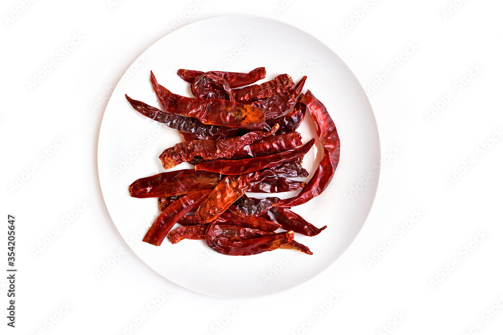 Red dried chili peppers on white plate Red dried chili peppers on white plate