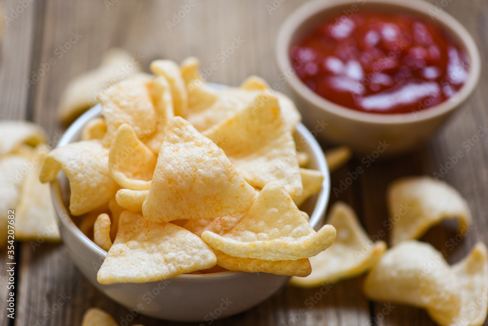 prawn crackers chips on white bowl and wooden table background - homemade crunchy prawn crackers or shrimp crisp rice and ketchup for traditional snack prawn crackers chips on white bowl and wooden table background - homemade crunchy prawn crackers or shrimp crisp rice and ketchup for traditional snack