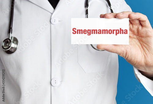 Smegmamorpha. Doctor in smock holds up business card. The term Smegmamorpha is in the sign. Symbol of disease, health, medicine photo