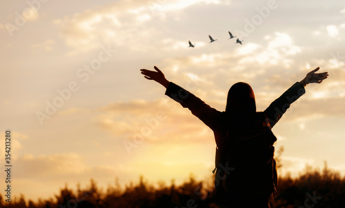 Freedom concept. Happy young woman enjoying freedom with open hands looking to the sky