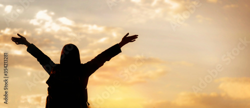 Freedom concept. Happy young woman enjoying freedom with open hands looking to the sky