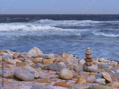 Cairn at the Cape of Good Hope, South Africa, with the surf coming ashore.
