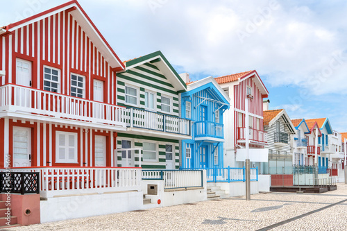 Street with colorful striped houses, Costa Nova, Aveiro, Portugal. Facades of colorful fisheman houses in Costa Nova, Aveiro, Portugal
