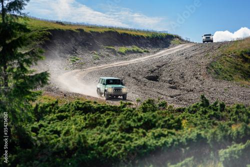 Off-road car riding on mountain road in Carpatians on summer day © Denys Kurbatov