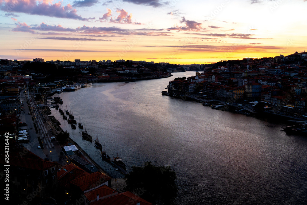 Sunset over Porto city center and Douro river, Portugal. Panorama old city Porto at river Duoro, with boats, Oporto.