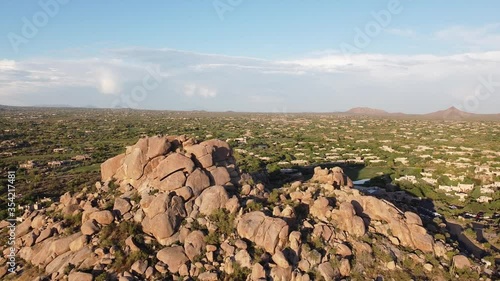 Ariel view of Boulders in North Scottsdale,CaveCreek & Carefree Arizona area.   Dolly in towards boulders, dramatic view of rugged desert landscape at early sunset. photo