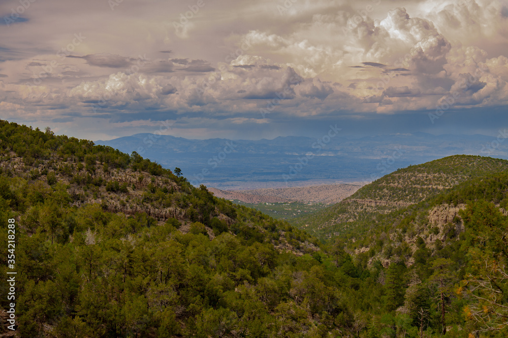 View from the Sandia Man Cave looking towards Placitas, outside of Albuquerque, New Mexico showing the green forest in the Sandia Mountains
