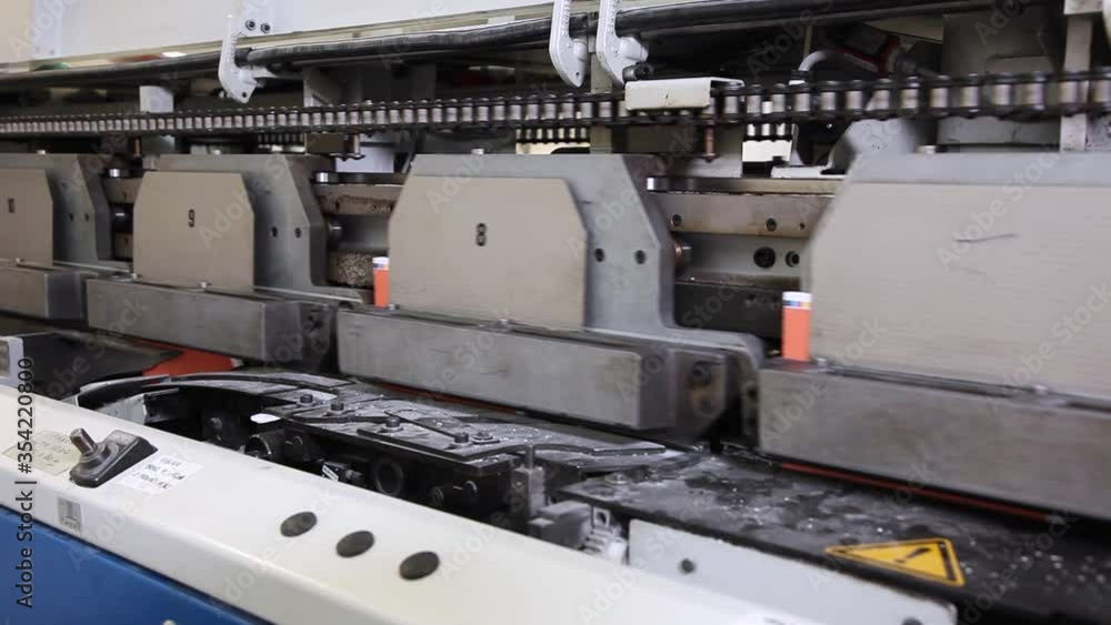 Books moving on a conveyor in a print office, modern technology. Stock