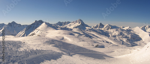 Panoramic view of the mountains of France on a winter sunny day. Haute Savoy, France. Snow Park. © as_trofey
