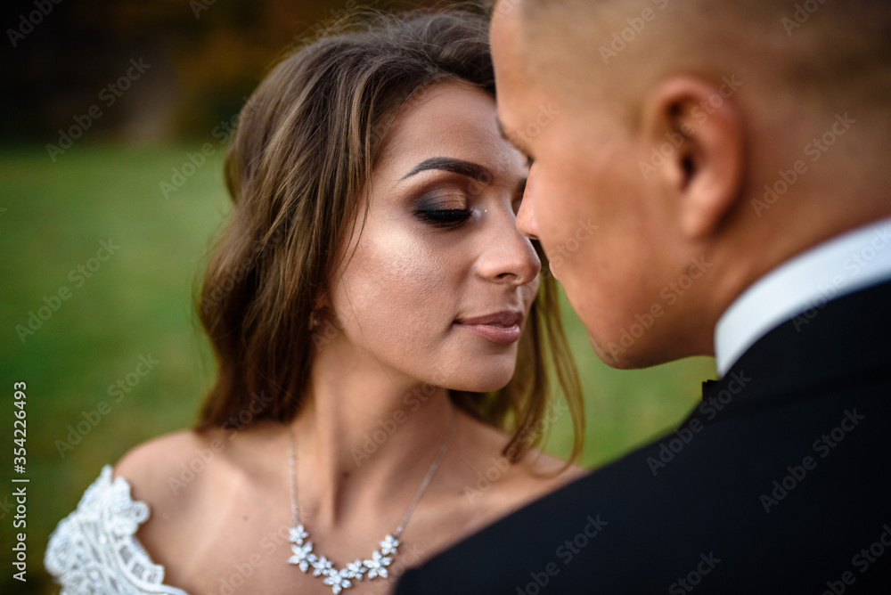 Newlyweds are hugging in the autumn forest. Close-up. Newlyweds are hugging in the autumn forest. Close-up.