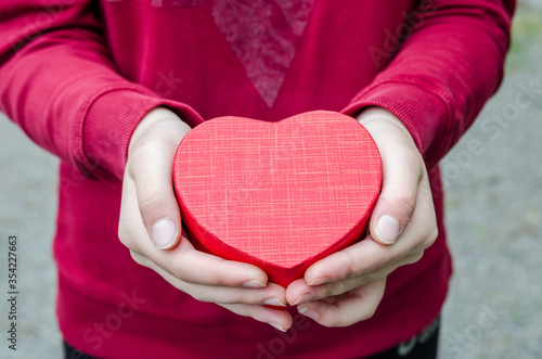 red heart in the hands of a girl.