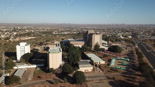 4K aerial drone summer sunny day video of Windhoek Katutura suburb large state hospital near B1 main highway in Namibia's capital in central highland Khomas Hochland of Namibia, southern Africa