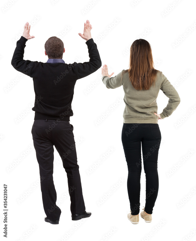Back view of couple in sweater showing thumbs up. Back view of couple in sweater showing thumbs up.