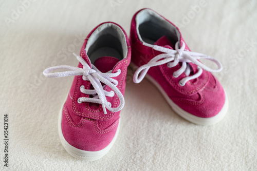 Little toddler pink leather shoes with white lace.