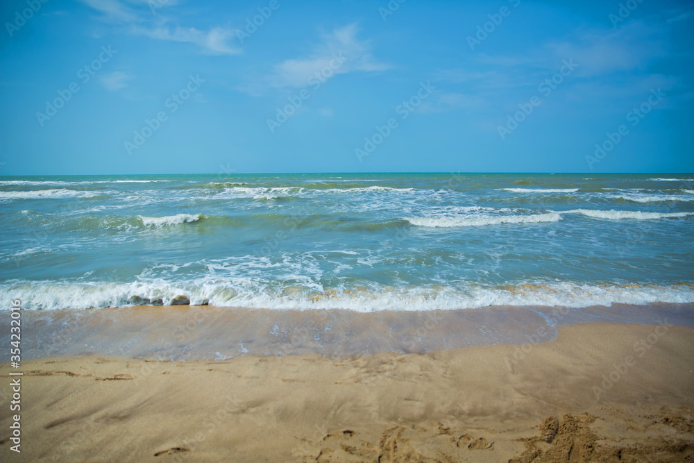 Fototapeta premium Tropical sea,Beach with Summer time. Close-up photo of beautiful beach with crystal clear turquoise water . Green and sky sea and the waves . Summer vacation background.