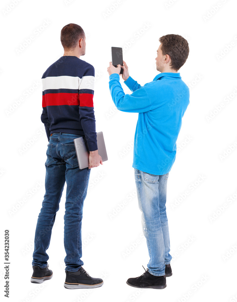 Back view of two man in sweater with mobile phone. Back view of two man in sweater with mobile phone.
