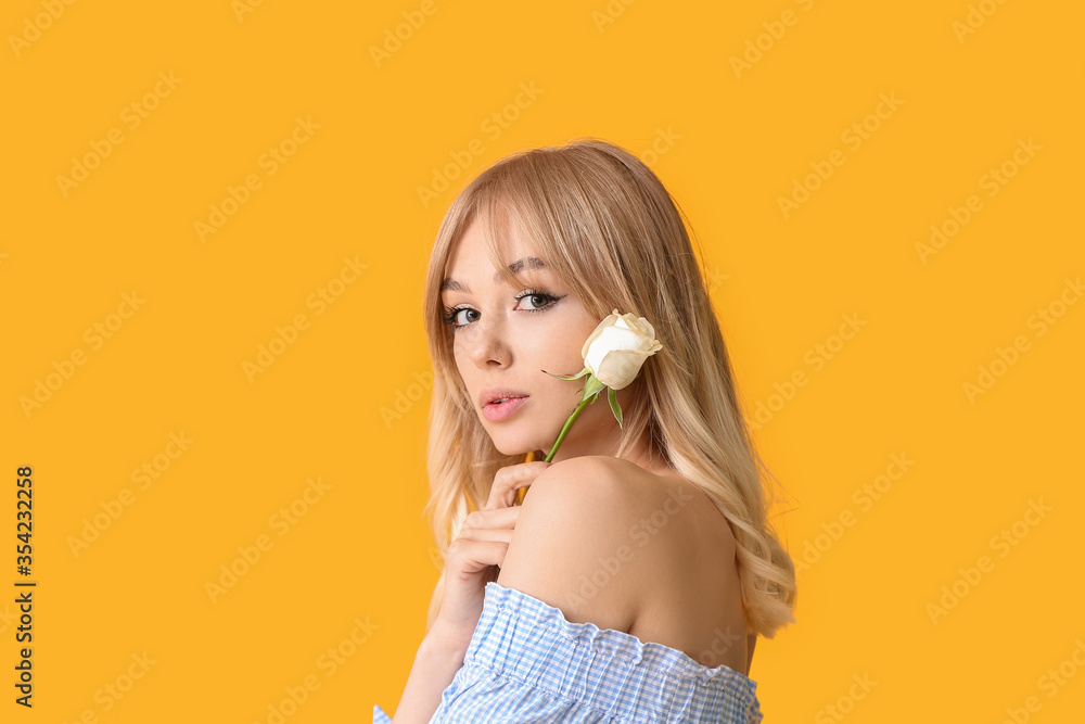 Beautiful young woman with rose on color background Beautiful young woman with rose on color background