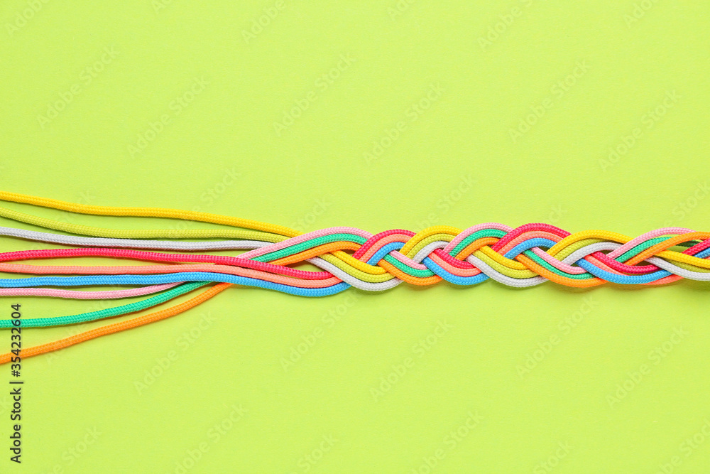 Braided ropes on color background. Unity concept Braided ropes on color background. Unity concept