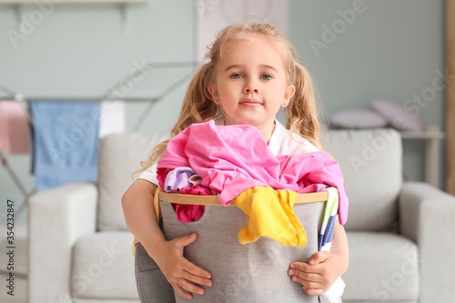 Little girl with dirty laun...