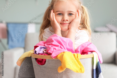 Little girl with dirty laun...