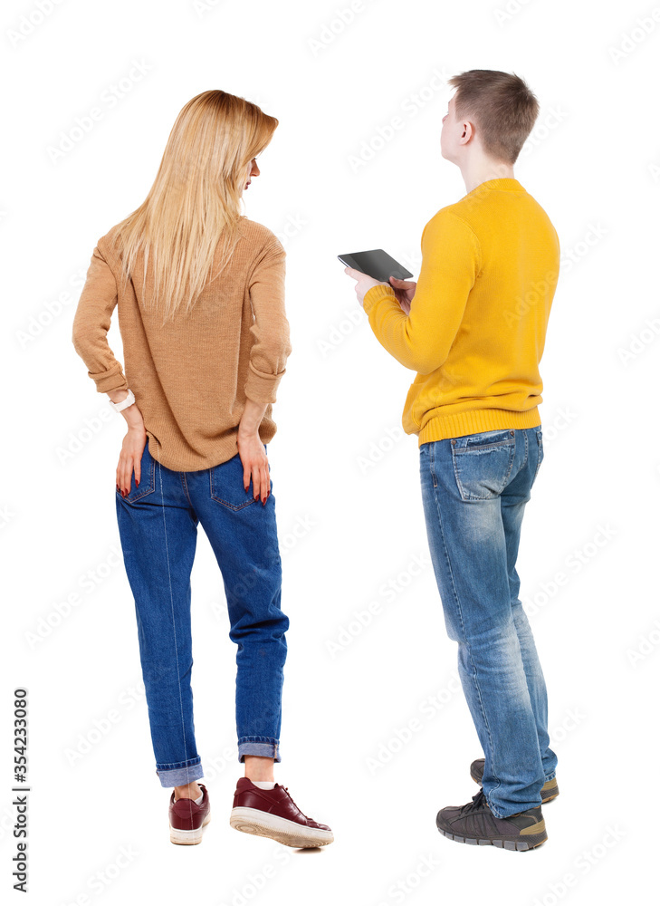 Back view of couple in sweater with mobile phone. Back view of couple in sweater with mobile phone.