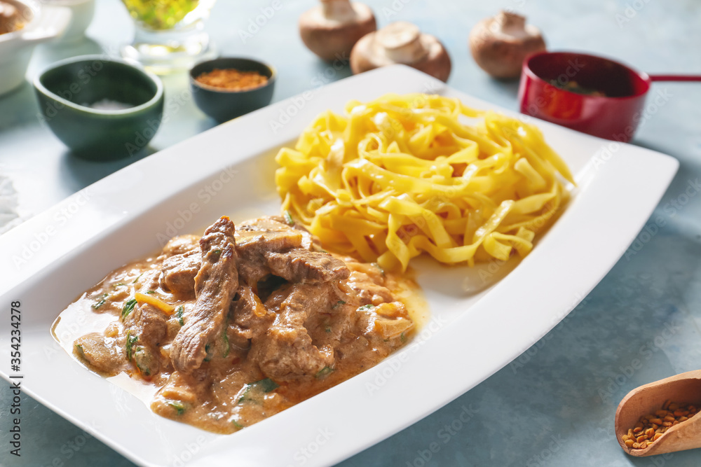Plate with tasty beef stroganoff and pasta, closeup Plate with tasty beef stroganoff and pasta, closeup