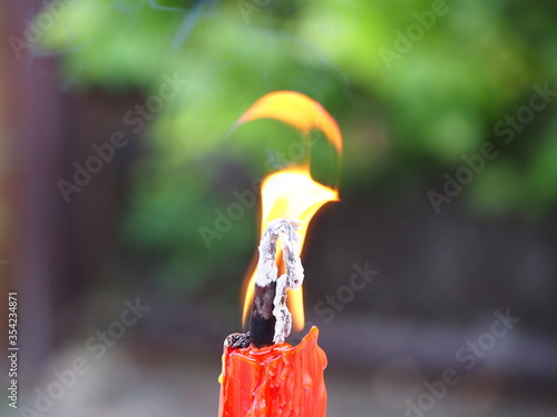 Close up of a burning candle flame. Melted Wax Candle light border design creating a spiritual atmosphere photo