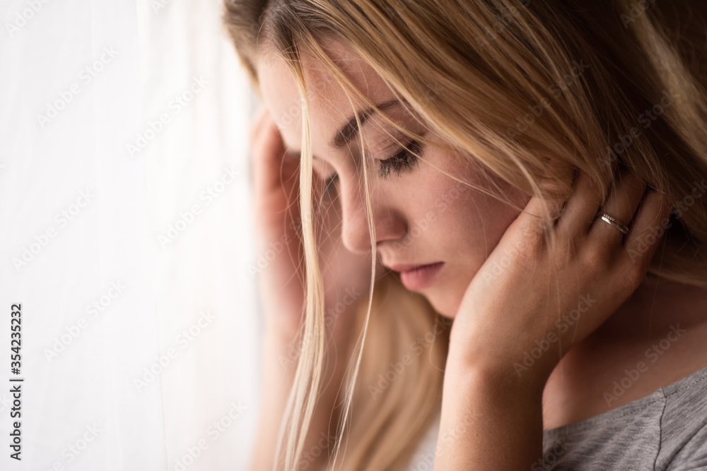 Fototapeta premium Young de-stressed woman looking downwards