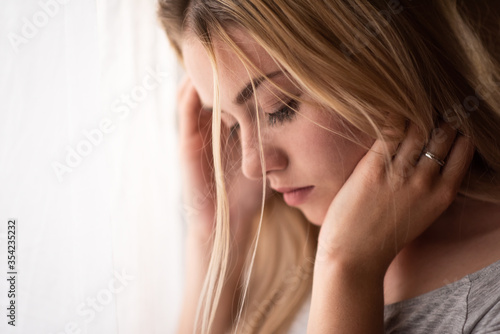 Young de-stressed woman looking downwards