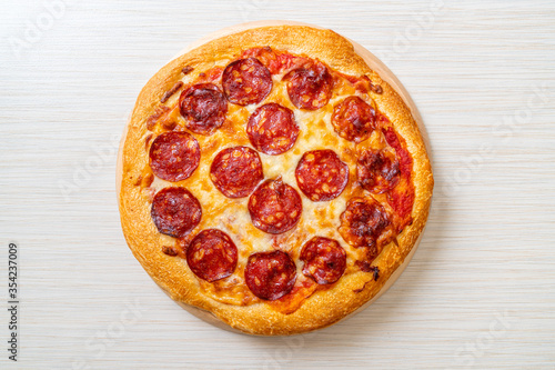 pepperoni pizza on wood tray