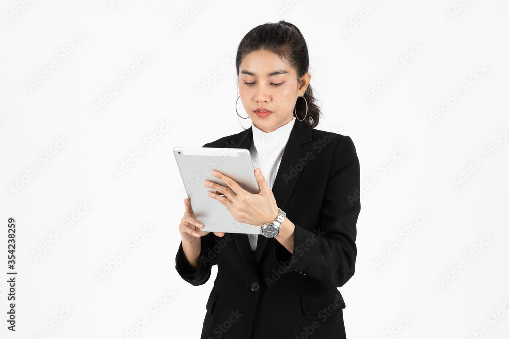 Professional young Asian business woman using tablet for work over white isolated background.