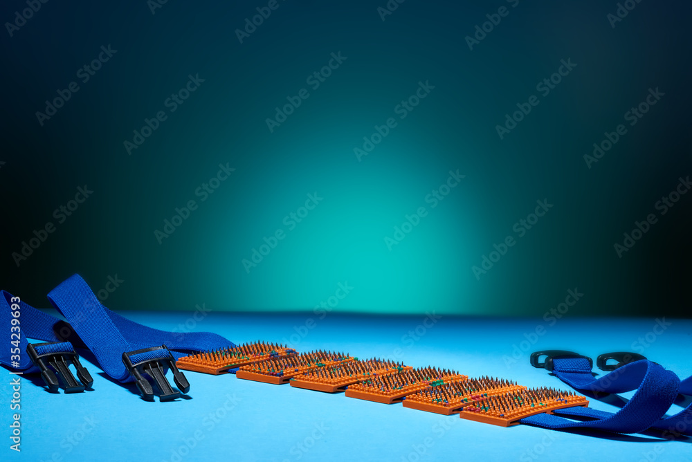 The orange-coloured massage belt with blue stripes lies horizontally on the arctic background and ocean surface. For relaxation and health. Advertising, thematic and subject shooting.