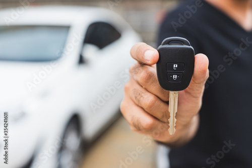 Businessman giving a car key. Getting new car.