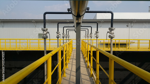 Fotografia Walk way with yellow handrail inside factory