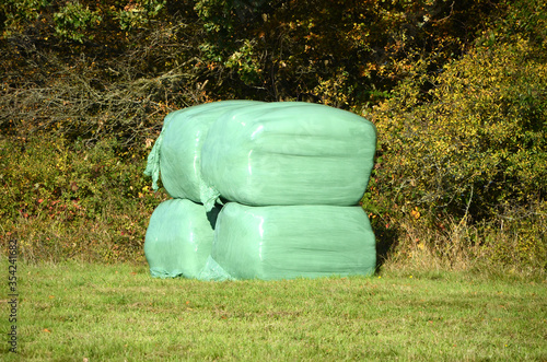 Small pile with silage bags on a field.