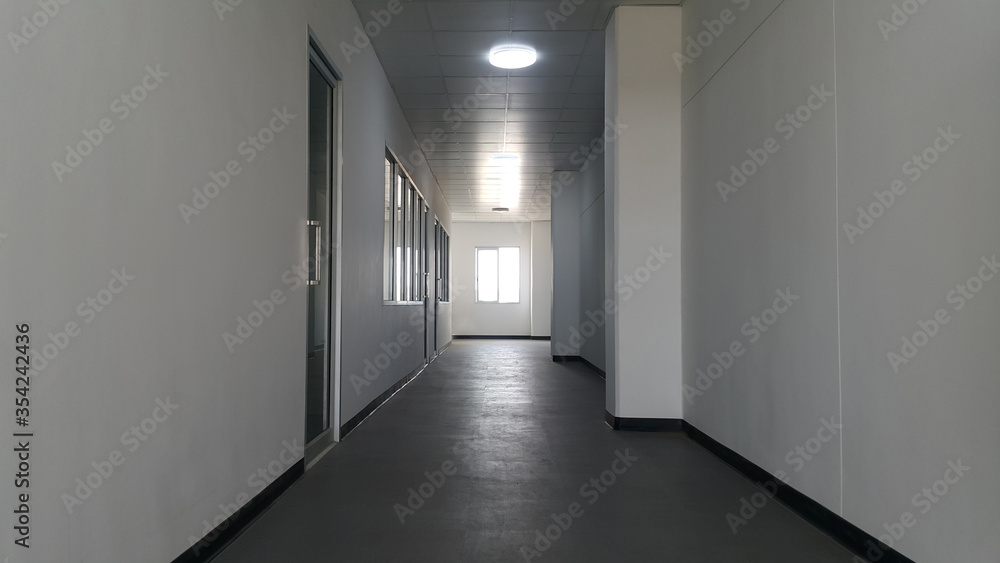 Corridor in office building with light in windows passing daylight