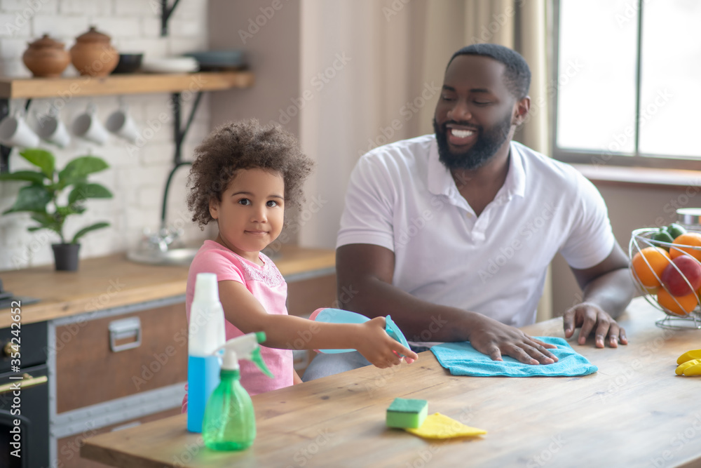 African american bearded man and his kid doing cleaning together and feeling great African american bearded man and his kid doing cleaning together and feeling great