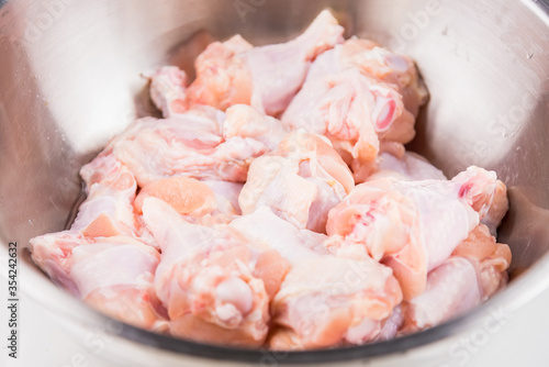 Raw Chicken wings (wingstick) in Stainless steel bowl