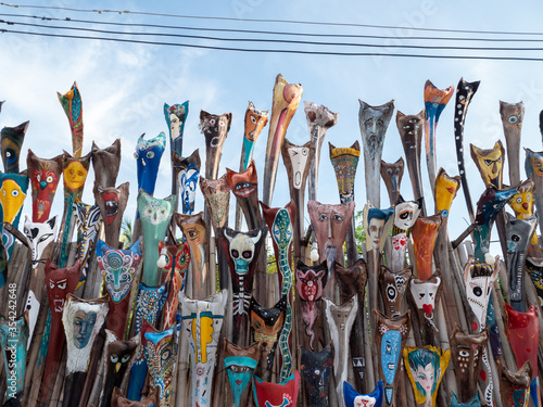 Colorful shamans masks on the art market wall at tropical island koh Phangan in Thailand