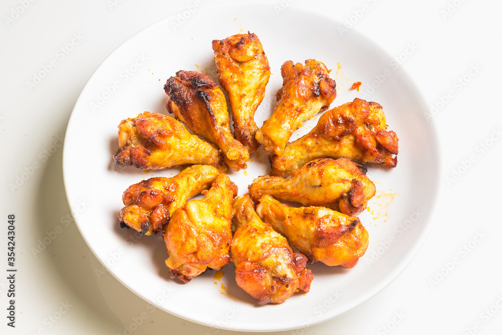 Grill BBQ Chicken Legs with oven air fryer.healthy cooking without oil.arranged on a large white plate.