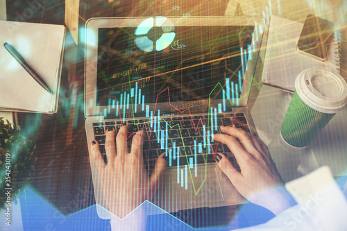 Double exposure of woman hands typing on computer and forex chart hologram drawing. Stock market invest concept.