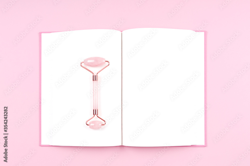 Journal with jade roller massager. Beauty time, selfcare, beauty log, feminine journal concept. Place for text Journal with jade roller massager. Beauty time, selfcare, beauty log, feminine journal concept. Place for text