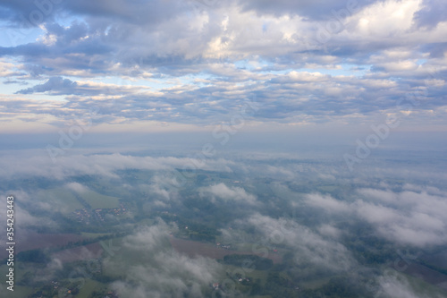 Summer nature landscape aerial panorama with sunrise. Morning fog and sunrise, meadow and forest and field.