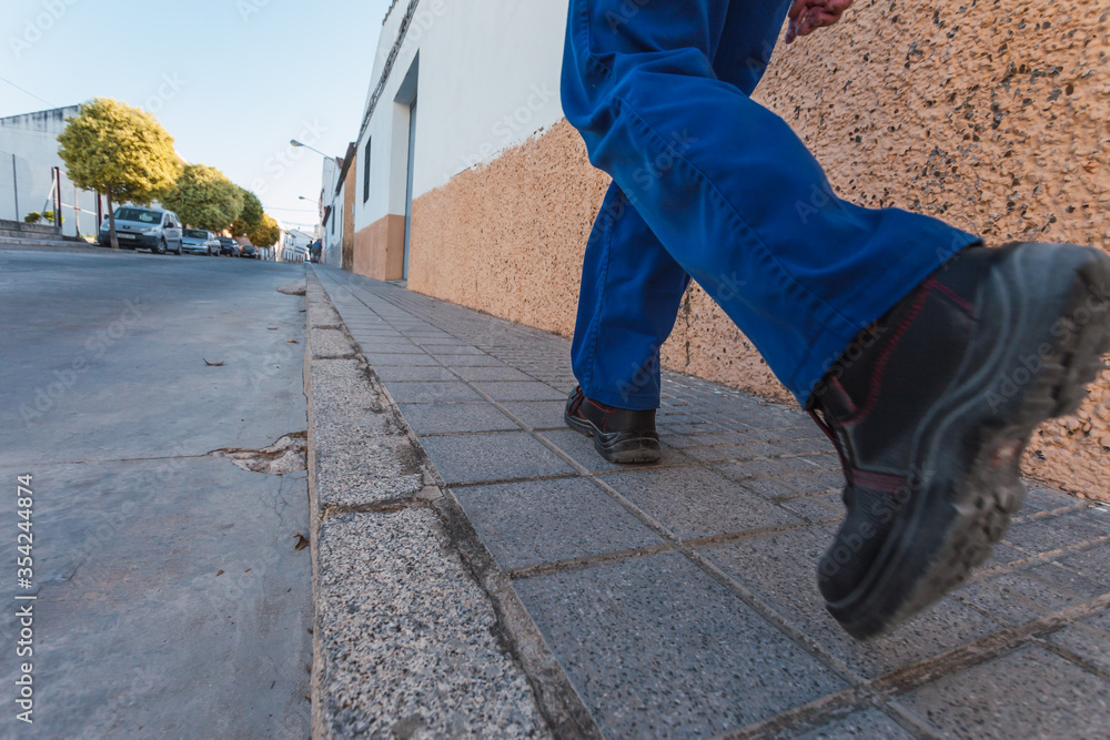 Feet of man walking down the street after confinement. Selective focus. Feet of man walking down the street after confinement. Selective focus.