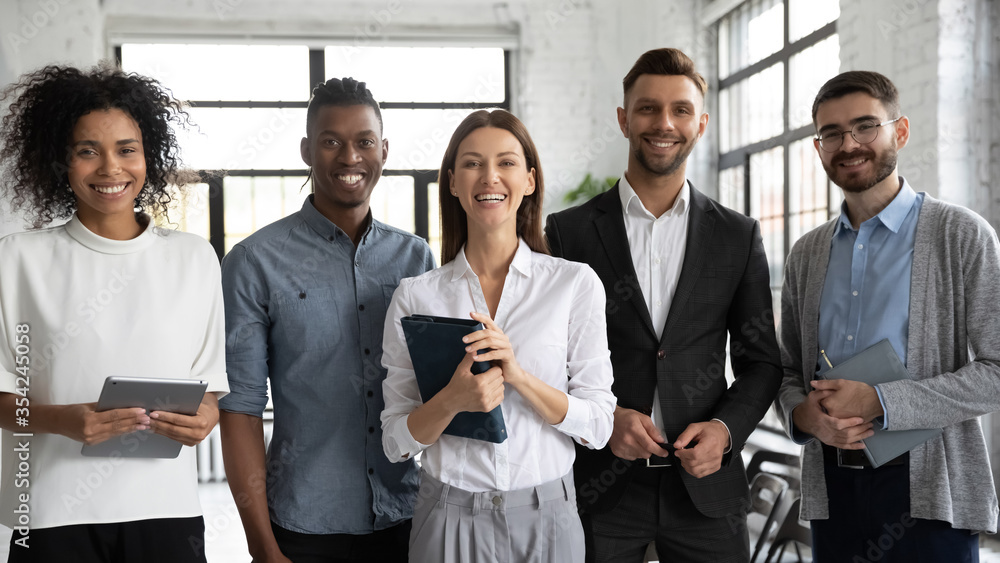 Corporate portrait successful smiling diverse employees team standing Corporate portrait successful smiling diverse employees team standing