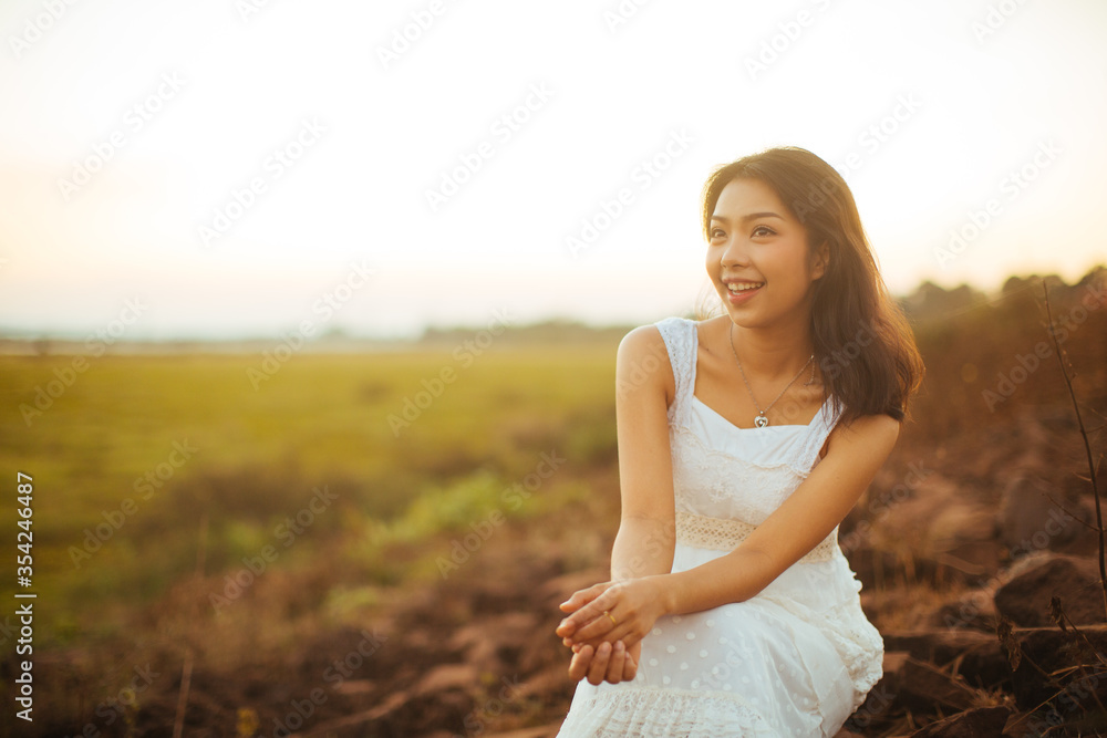 Portrait of beautiful woman smiling at park during sunset. Outdoor portrait of a smiling asian woman. Portrait of beautiful woman smiling at park during sunset. Outdoor portrait of a smiling asian woman.