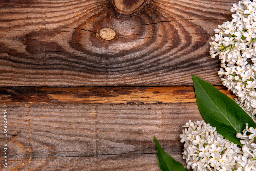 Fototapeta premium Bouquet of white lilac on a old wooden background. Top view