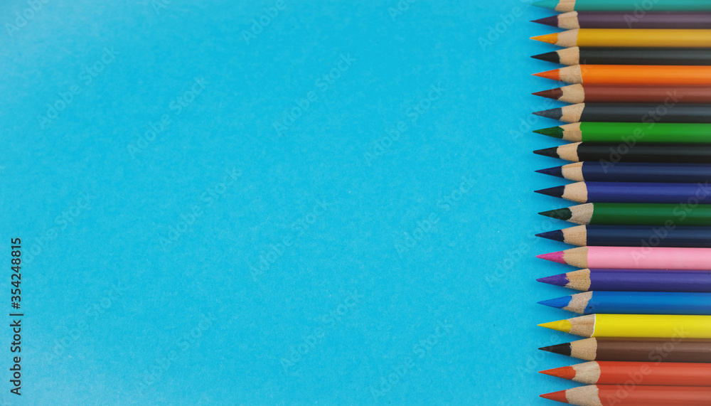 Colourful pencils on pink background, place for a text Colourful pencils on pink background, place for a text