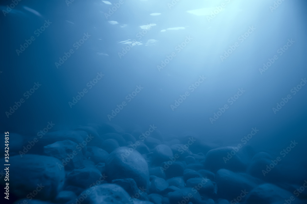 stones at the bottom underwater landscape, abstract blurred under water background stones at the bottom underwater landscape, abstract blurred under water background